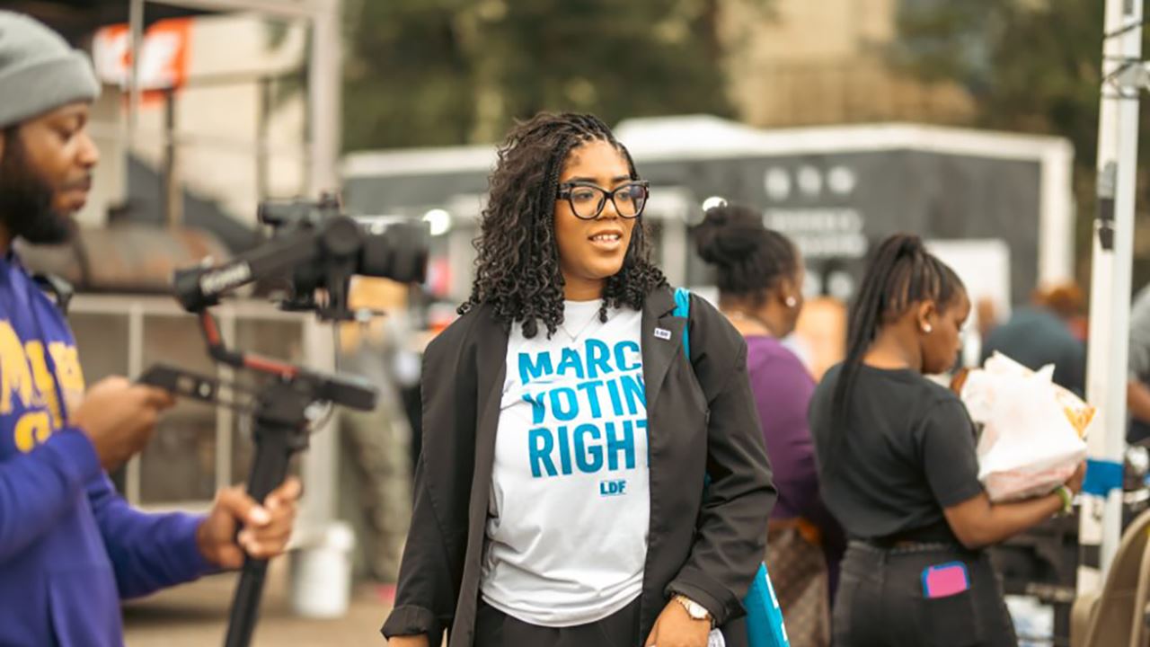 Woman wearing a "March for Voting Rights" t-shirt