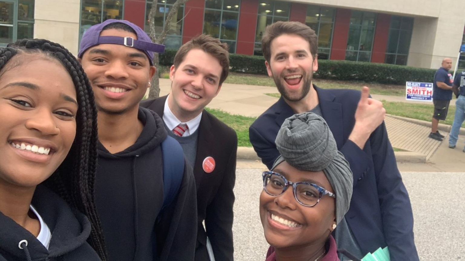 Young volunteers outside of a polling location