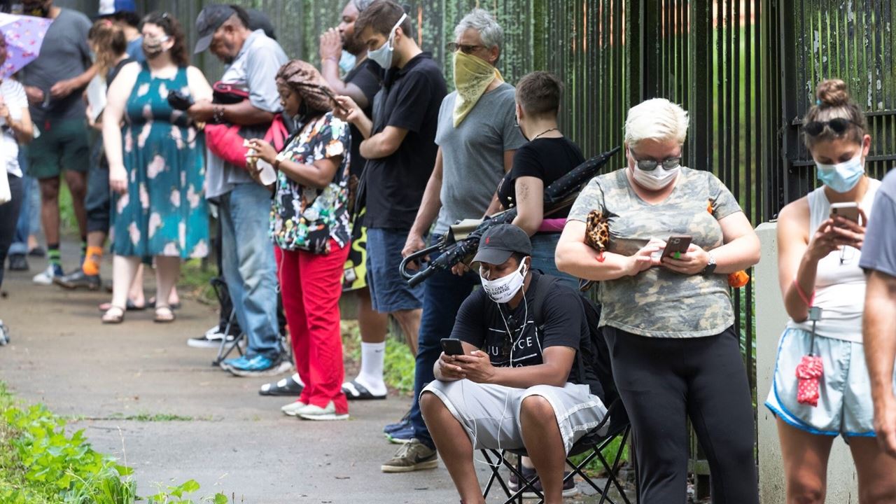 People standing in line with masks on