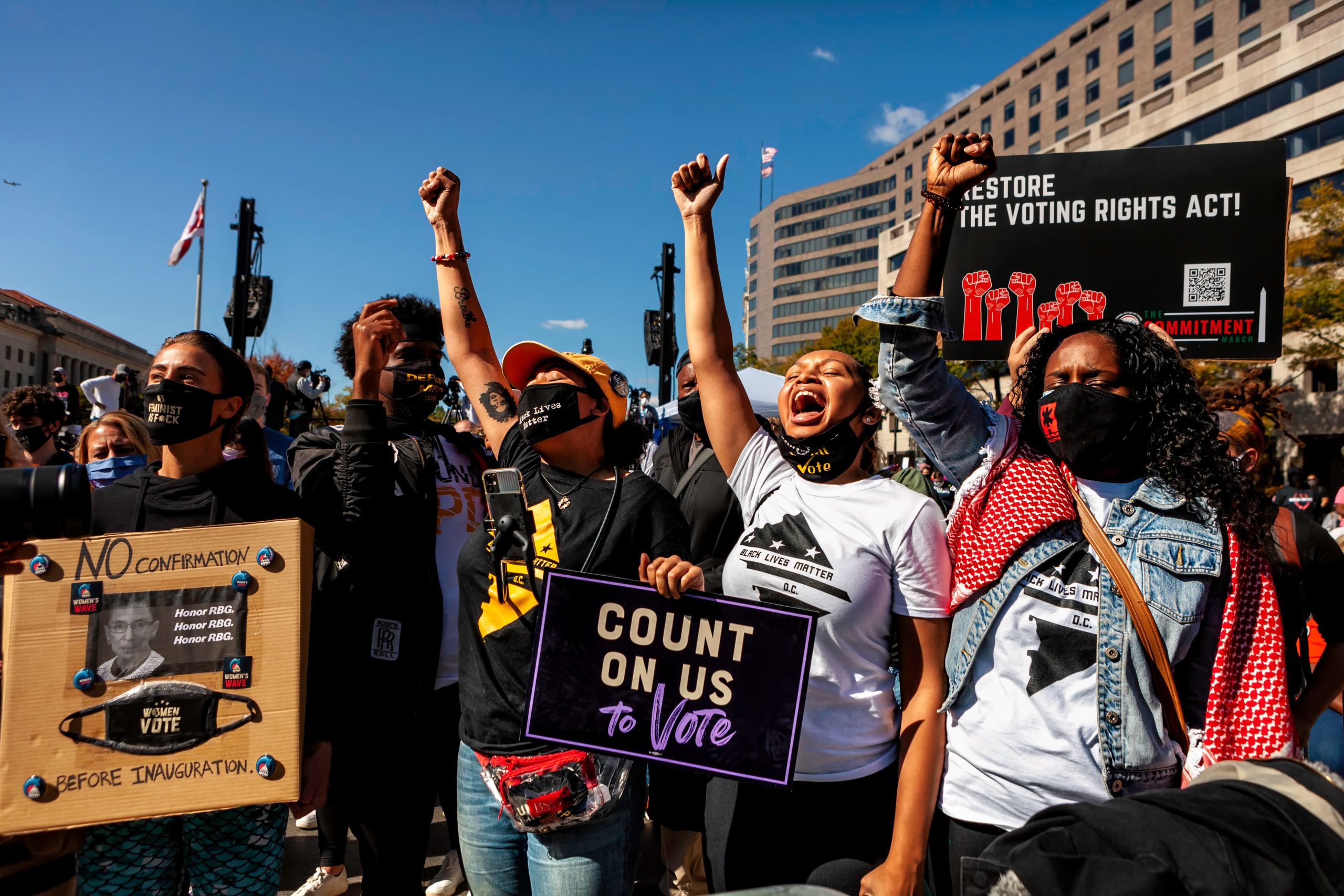 Activists holding signs promoting voting rights