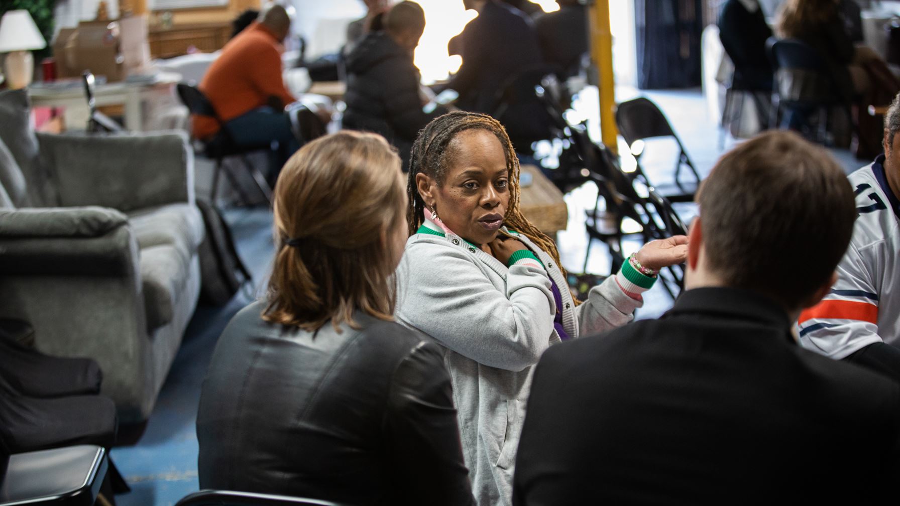 Close-up picture of an African-American engaged in conversation at a community event.